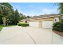Spacious three-car garage with extended driveway and lush greenery at 343 Leslie Ln, Lake Mary, FL 32746