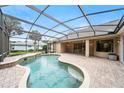Inviting screened-in pool area with brick patio and lush landscaping at 343 Leslie Ln, Lake Mary, FL 32746