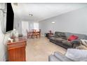 Living room and dining area with neutral paint, and tile flooring perfect for comfortable living and entertaining at 3887 Atrium Dr # 3, Orlando, FL 32822