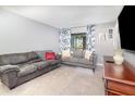 Living room featuring comfortable sofas, tiled floor, and natural light for a cozy atmosphere at 3887 Atrium Dr # 3, Orlando, FL 32822