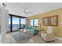 Bright living room featuring ocean views, a comfortable sofa, and tile floors at 4141 S Atlantic Ave # 707, New Smyrna Beach, FL 32169