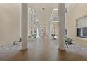 Unique hallway with courtyard view and neutral walls at 4650 Links Village Dr # B103, Ponce Inlet, FL 32127