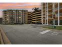 Condominium parking garage with a multi-level parking structure and palm trees at 4650 Links Village Dr # B103, Ponce Inlet, FL 32127