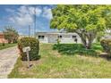 Charming single-story home surrounded by mature trees and lush green lawn at 603 Carver Dr, Lake Wales, FL 33853