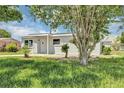 Well-maintained single-story home with a manicured lawn and mature trees at 603 Carver Dr, Lake Wales, FL 33853