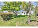 Charming single-story home showcasing a well-manicured lawn and mature trees at 603 Carver Dr, Lake Wales, FL 33853