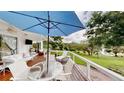 Relax on this outdoor deck with table, seating, and sun umbrella, while enjoying serene nature views at 625 Woodlawn Cemetery Rd, Gotha, FL 34734
