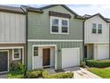 Inviting two-story townhome with a one-car garage and charming, well-maintained landscaping at 827 Grandin St, Davenport, FL 33837