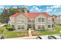 Multi-Gathering building with red tile roof and well-kept landscaping, offering a classic and inviting curb appeal at 900 Northern Dancer Way # 204, Casselberry, FL 32707