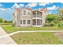 Charming condo featuring a red tile roof, well-maintained lawn, and a screened porch, perfect for relaxing outdoors at 900 Northern Dancer Way # 204, Casselberry, FL 32707