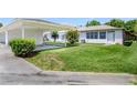 The house showcases a covered parking area, a well-manicured lawn and nice bushes at 901 Illinois Ave, St Cloud, FL 34769