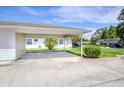This lovely house has a covered parking area, with a view of a green front lawn at 901 Illinois Ave, St Cloud, FL 34769