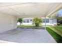 View of the concrete parking area with the lawn at 901 Illinois Ave, St Cloud, FL 34769