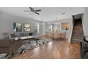 Well-lit living space with hardwood floors and open access to the kitchen and dining area at 976 Rock Harbor Ave, Orlando, FL 32828