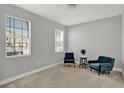Neutral bedroom featuring a chair by the window with natural light, plush carpet, and fresh paint at 1061 Castlevecchio Loop, Orlando, FL 32825