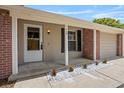 Inviting covered front porch with brick accents, minimalist landscaping, and a secure front door at 110 Rabun Ct, Sanford, FL 32773