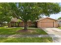 Charming single-story home with mature landscaping and a two-car garage at 119 Glendale Dr, Longwood, FL 32750