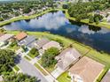 An aerial view of a home with a beautiful pond view and lush landscaping in a desirable neighborhood at 1252 Ballyshannon Pkwy, Orlando, FL 32828