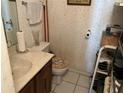 Small bathroom features a vanity, toilet, and decorative wallpaper at 1409 Oak Pl # F, Apopka, FL 32712