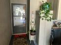 Inviting entryway with a storm door and decorative plants; a welcoming scene at 1409 Oak Pl # F, Apopka, FL 32712