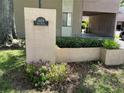 Exterior shot of building with well-maintained landscaping with sign reading 1409 Oak Place at 1409 Oak Pl # F, Apopka, FL 32712