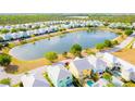 Beautiful aerial view of a residential community with a central lake and colorful homes at 1545 Fairview Cir, Reunion, FL 34747