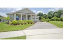 Beautiful home with lush landscaping, a brick driveway, and a cozy front porch, perfect for enjoying the outdoors at 1774 Pasture Loop, Oviedo, FL 32765