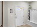 Bright foyer features a white front door with sidelight, neutral walls and built-in shelving at 1909 Majorca Dr, Kissimmee, FL 34747