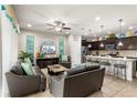 Open concept living room and kitchen featuring neutral tile floors and modern decor at 1909 Majorca Dr, Kissimmee, FL 34747