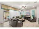 Comfortable living room with tiled floors opens to a screened patio and outdoor living space at 1909 Majorca Dr, Kissimmee, FL 34747