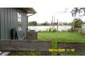 A view of the lake in the backyard, surrounded by lush greenery and mature trees at 1952 English Dr, Deltona, FL 32738