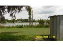 A serene lakeside view from the backyard, featuring calm water and natural surroundings at 1952 English Dr, Deltona, FL 32738