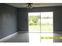 Bright living room with sliding glass doors showcasing a scenic view and great natural light at 1952 English Dr, Deltona, FL 32738