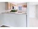 Bright kitchen with wood cabinets, white appliances, and modern design elements at 208 Scottsdale Sq # 208, Winter Park, FL 32792