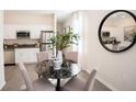 Cozy dining area adjacent to the kitchen features a modern table and stylish decor at 2191 Rider Rain Ln, Apopka, FL 32703