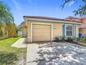 Charming single-story home featuring a terra cotta roof, and an attached garage at 2422 Condado Ct, Kissimmee, FL 34743