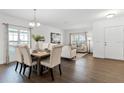 Bright dining area boasts hardwood floors, a large window, and an open floorplan leading to the living room at 2432 Riviera Ln, Minneola, FL 34715