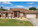 Beautiful home boasts a manicured lawn, landscaping, and a spacious two-car garage at 2558 Ballard Ave, Orlando, FL 32833