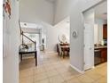 Spacious foyer showcases tile flooring, access to dining, living area, and a staircase to the upper level at 2616 Bowring St, Kissimmee, FL 34747