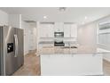 Bright kitchen with stainless steel appliances, granite counters, and a functional island at 2778 Virginia Pine Dr, Bartow, FL 33830
