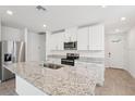 Modern kitchen featuring stainless steel appliances, granite countertops, and white cabinetry at 2778 Virginia Pine Dr, Bartow, FL 33830