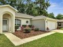 Close-up of a home's entrance showing manicured shrubs and a well maintained lawn at 2823 Ne 24Th Pl, Ocala, FL 34470