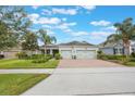 Charming single-story home with a two-car garage, manicured lawn, and lush landscaping at 31961 Redtail Reserve Blvd, Sorrento, FL 32776