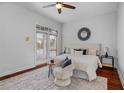 Bright primary bedroom with hardwood floors, a cozy chair, and plenty of natural light at 3713 Ocita Dr, Orlando, FL 32837