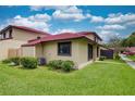 The exterior of this home features well manicured lawn and a red tile roof at 513 Hunter Cir # 513, Kissimmee, FL 34758