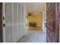 The foyer features tiled floors, closet, and a glimpse into the living area at 513 Hunter Cir # 513, Kissimmee, FL 34758