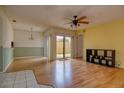 Open living area with hardwood floors, ceiling fan, and sliding glass doors to the outside at 513 Hunter Cir # 513, Kissimmee, FL 34758