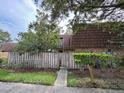 Charming townhome featuring a beautiful wooded exterior behind a fence and lush landscaping at 5302 Bamboo Ct # 447, Orlando, FL 32811