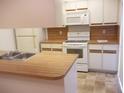 Kitchen features white cabinets and appliances at 5327 Bamboo Ct # 426, Orlando, FL 32811