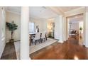 Elegant dining room featuring decorative columns, neutral tones, and a modern table set for six at 5350 Penway Dr, Orlando, FL 32814
